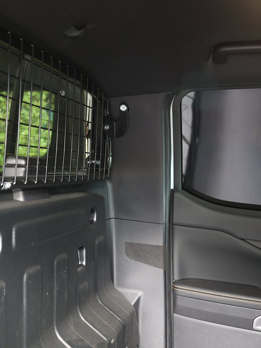The mesh bulkhead and load floor Ford fits to the Ranger 2-Seat, before removal